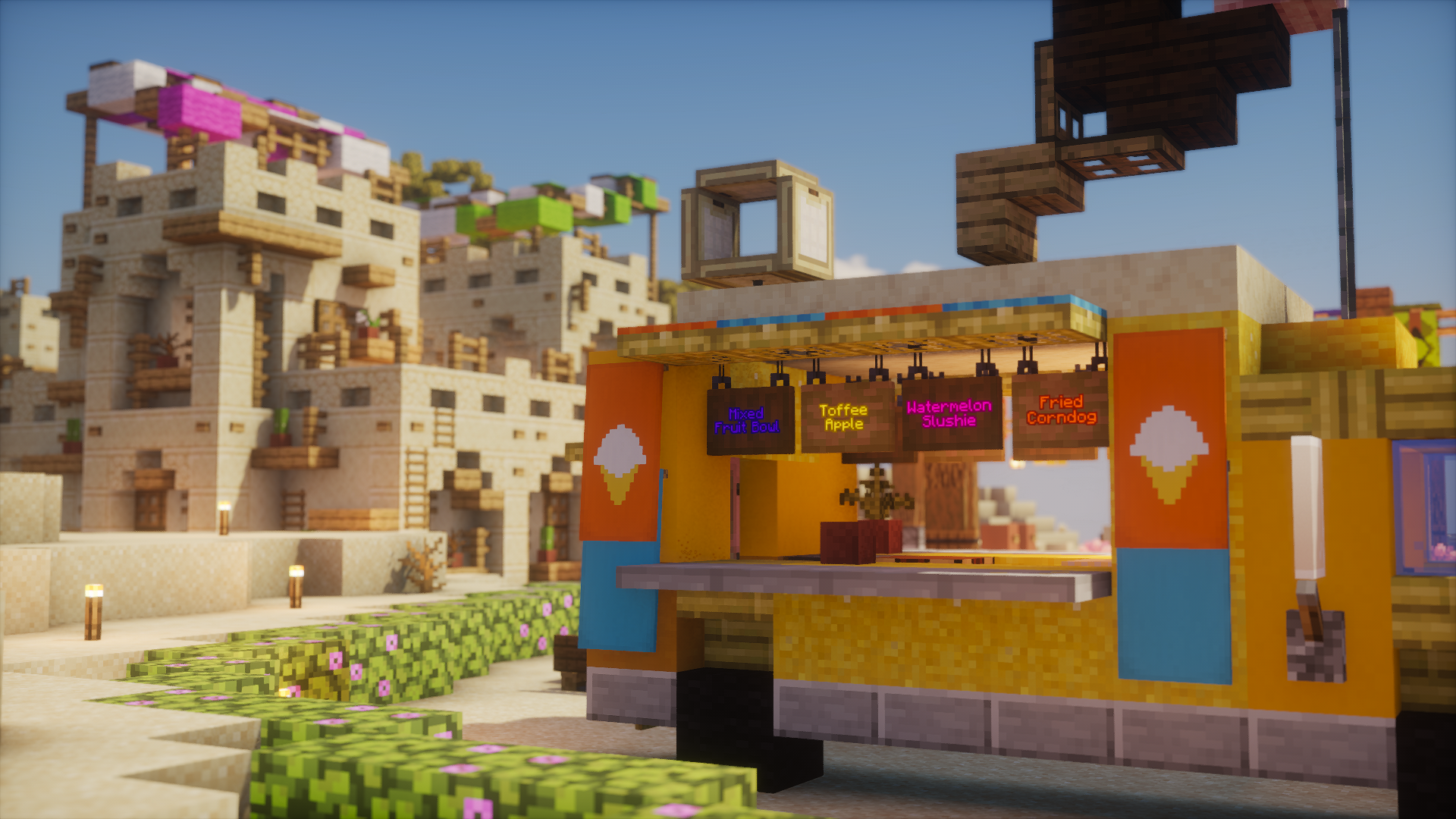 A colorful ice cream stand in front of sandstone homes
