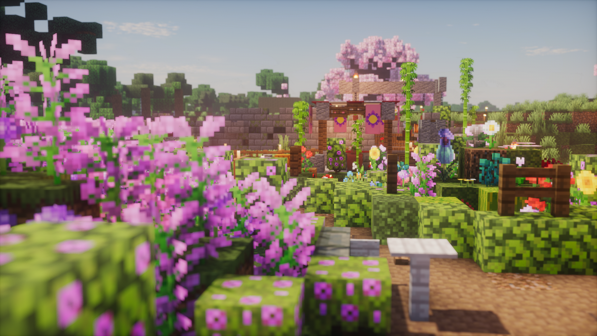 A garden path bordered by lavender, flowering hedges, and bamboo