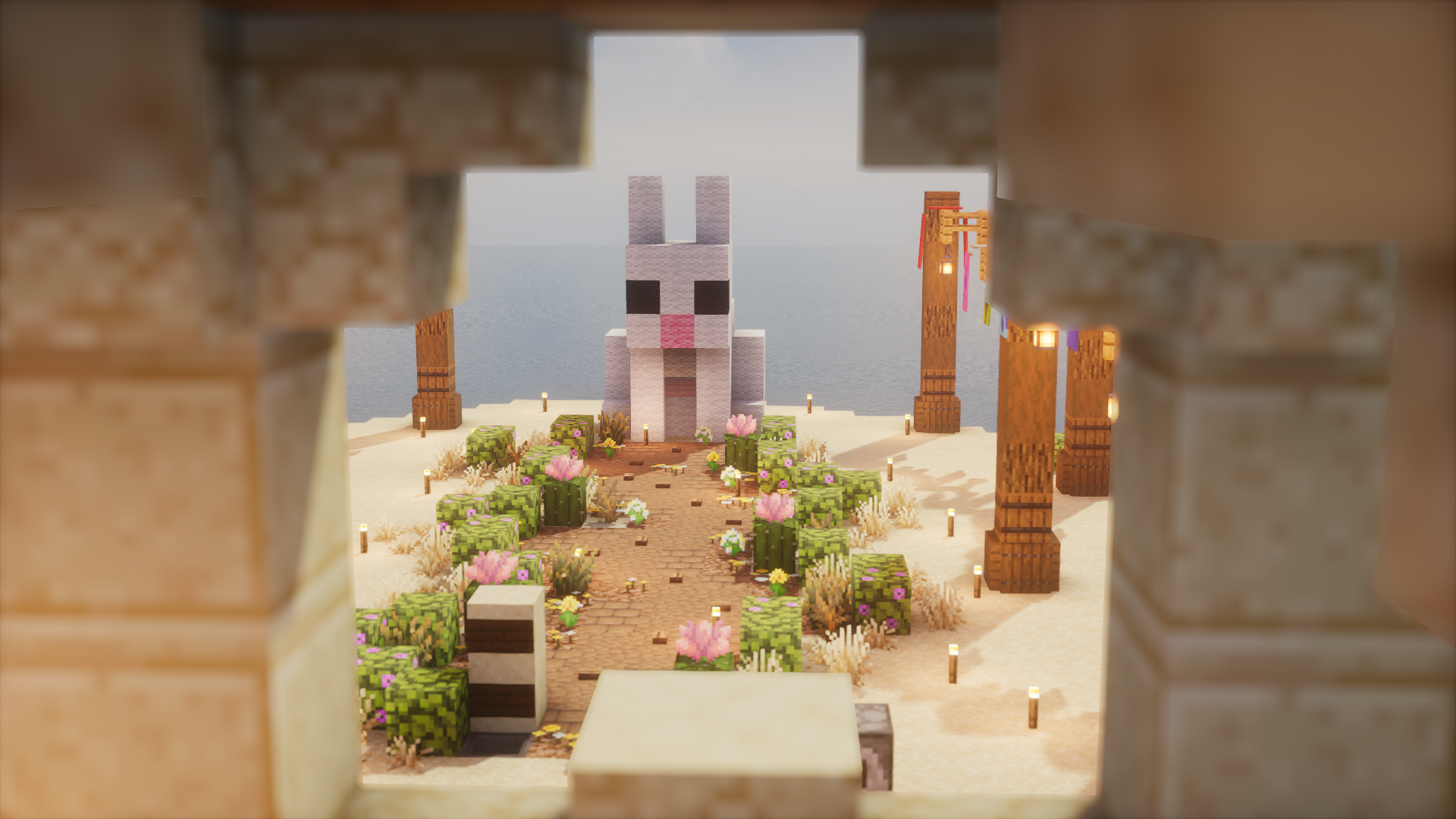 A flower-lined desert path leading to Tingletown’s Rabbit Event Statue