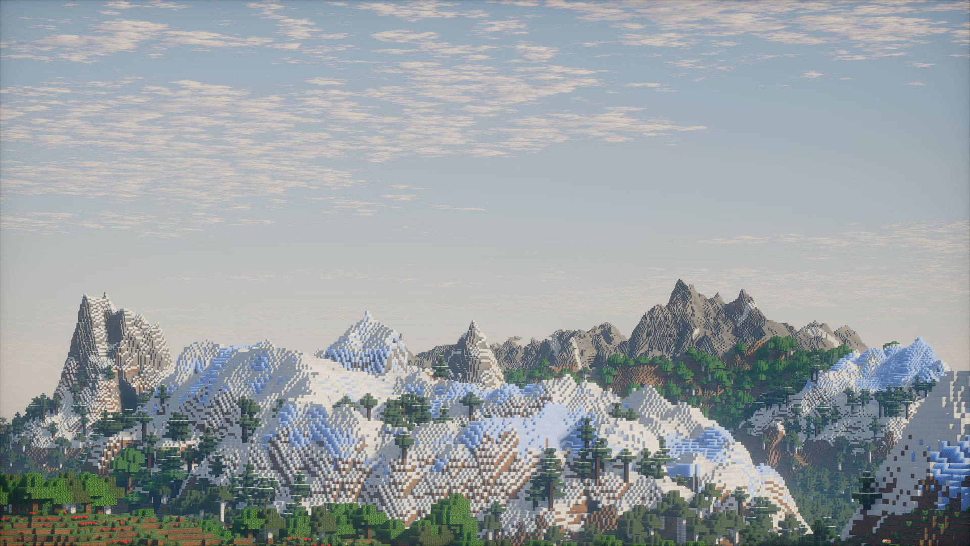 A vast range of snow-covered Minecraft mountains above a spruce forest